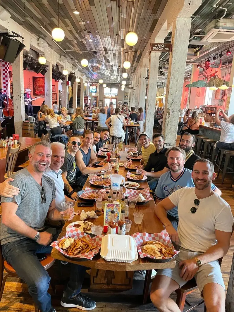 A Little Local Flavor food tour group of guys eating at Acme Feed and Seed in downtown Nashville
