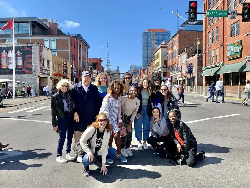 A Little Local Flavor food tour group walking on Broadway in downtown Nashville