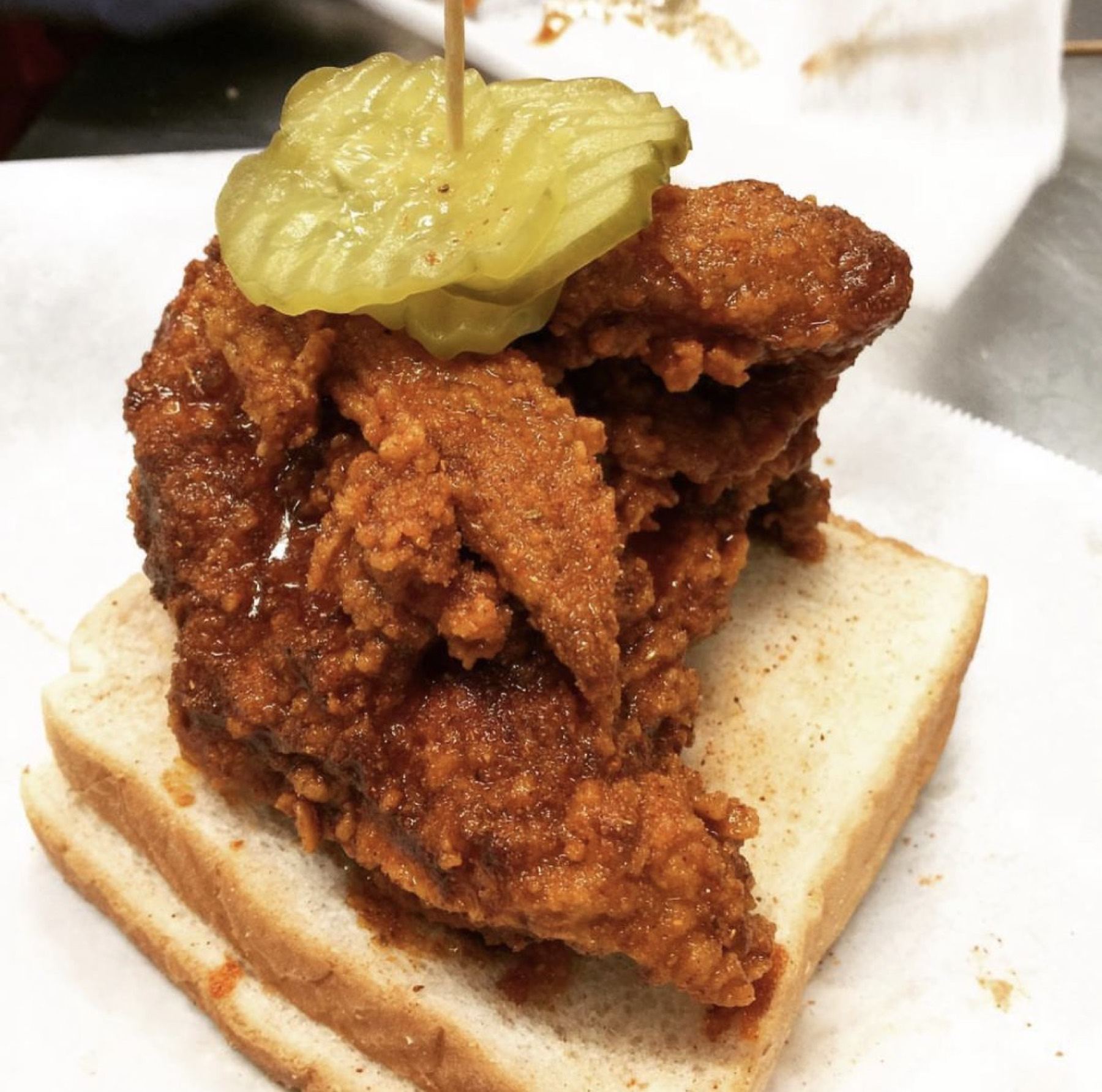 Nashville hot chicken on white bread with pickles
