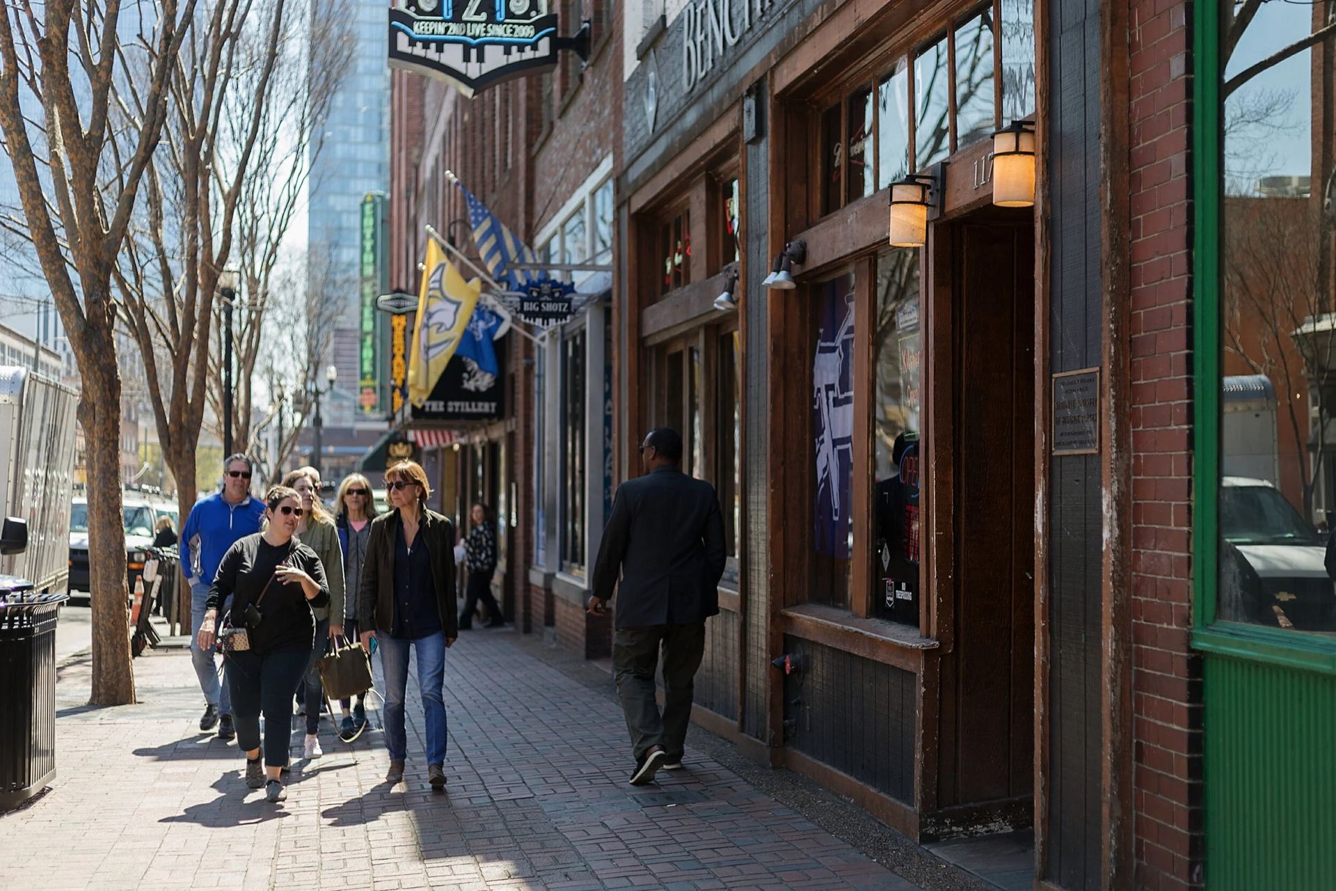 A guide leading a food tour group along Broadway in downtown Nashville