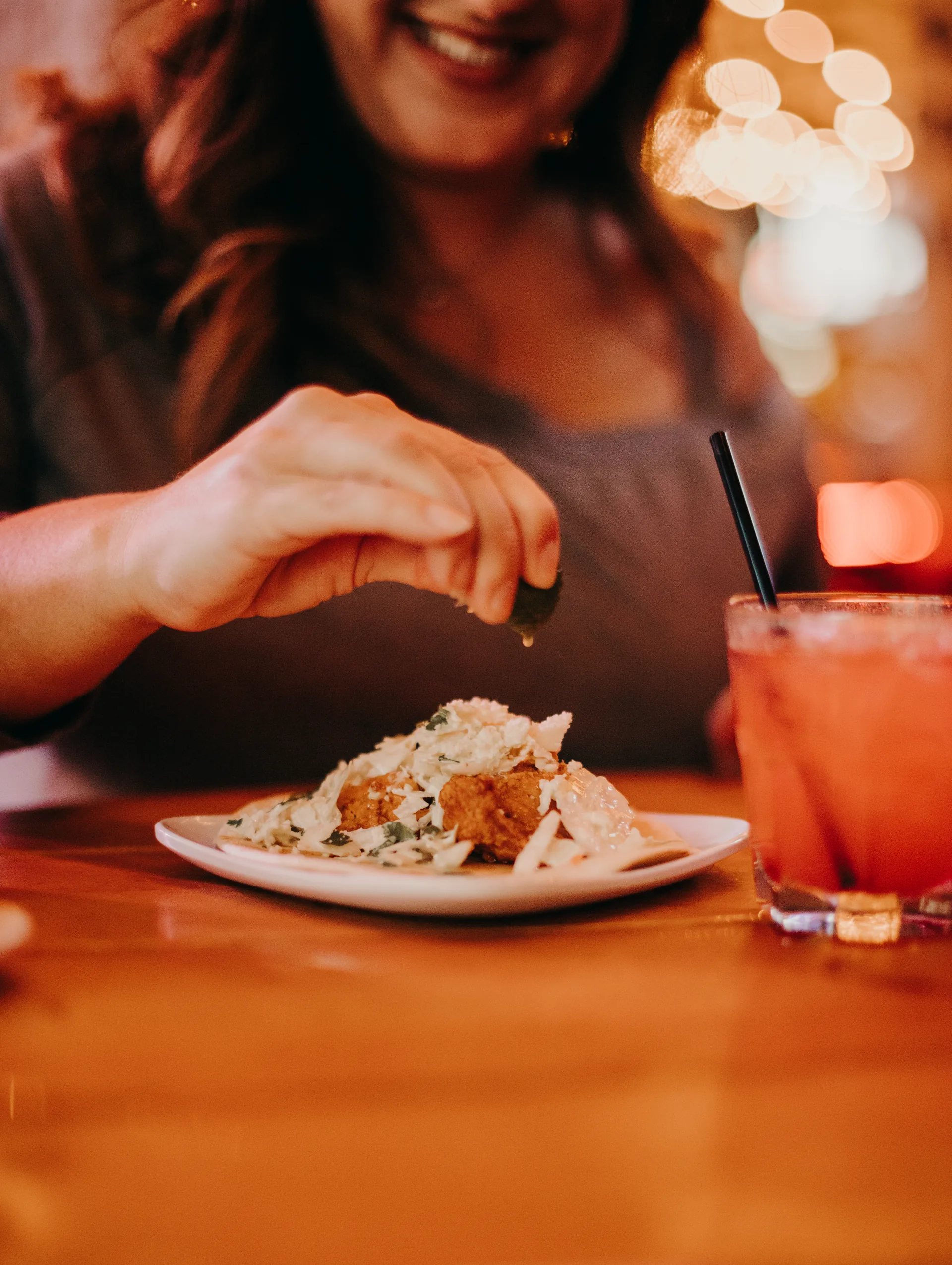 Squeezing fresh lime over a dish at a Nashville food tour stop